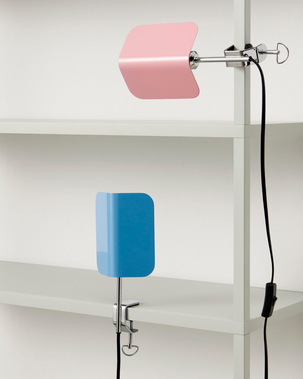 The Apex clip lamp can be fixed to horizontal and vertical surfaces, shown in Luis Pink and Pastel Blue 