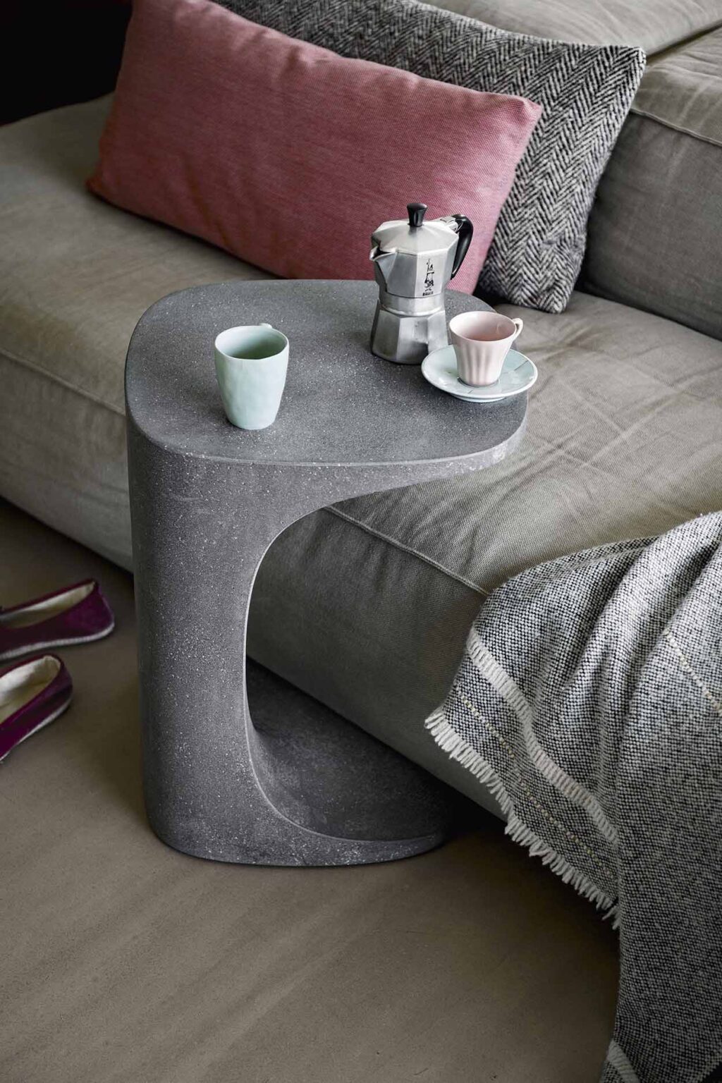 Font occasional table in dark concrete used as a coffee table